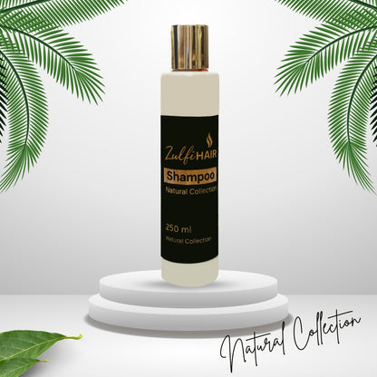 Zulfi Hair Herbal Shampoo 250ml bottle from Natural Collection on white pedestal with green leaves
